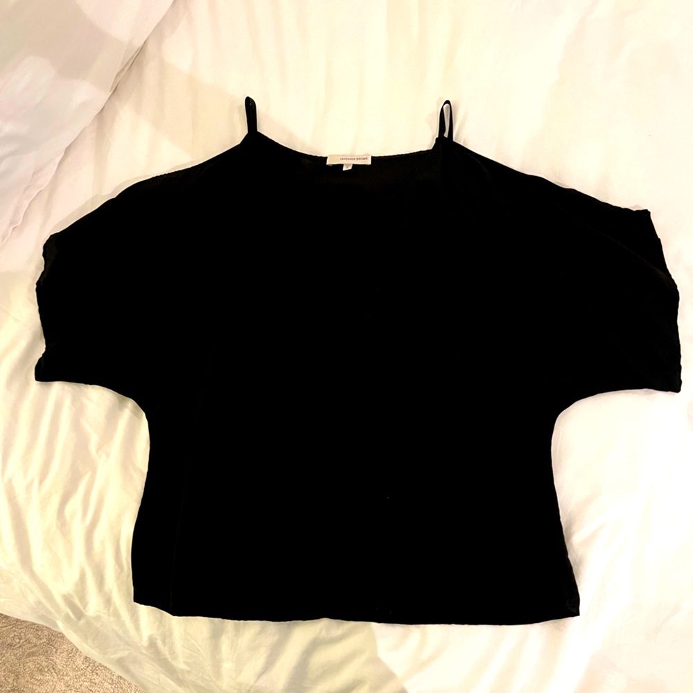 Black blouse with open shoulder cutouts.